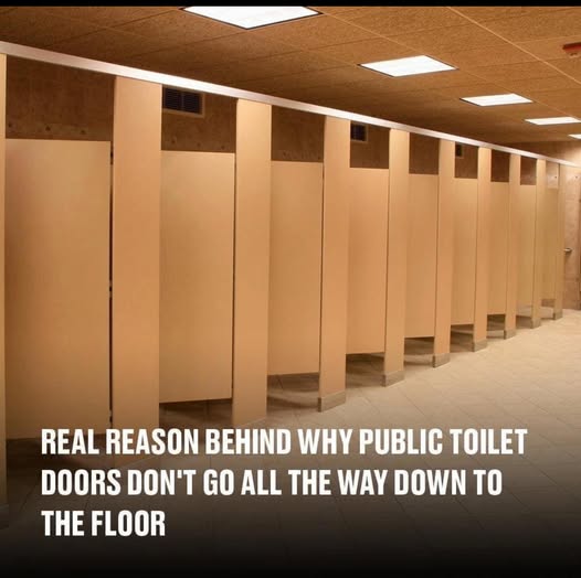 Why do public bathroom doors not reach the floor?