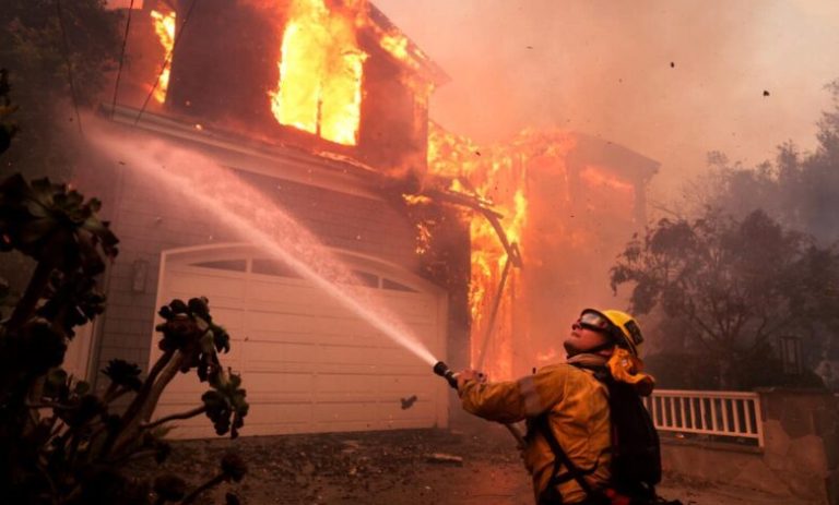 Firefighters battled into the night against the wildfire that roared through the affluent Pacific Palisades neighborhood in Southern California on Tuesday, destroying homes and forcing at least 30,000 residents to evacuate.