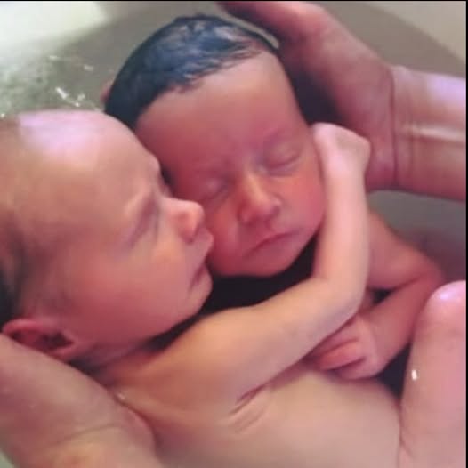 Newborn twins won’t stop cuddling like they did in the womb